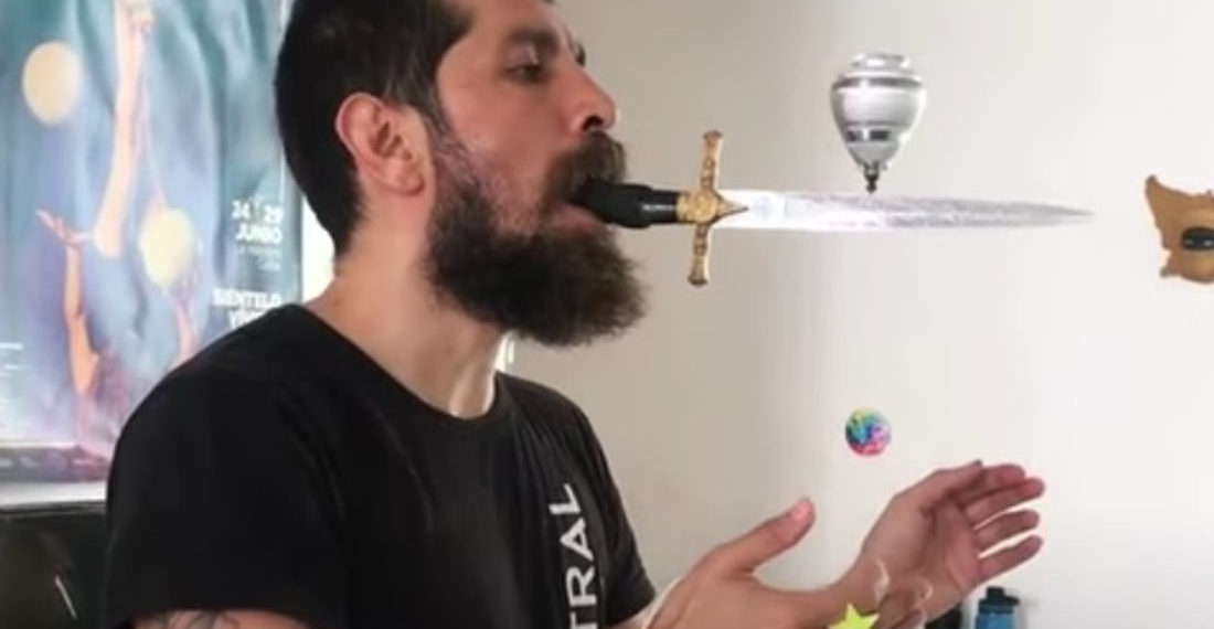 Dare To Dream: Guy Balances Spinning Top On Blade Of Dagger In Mouth