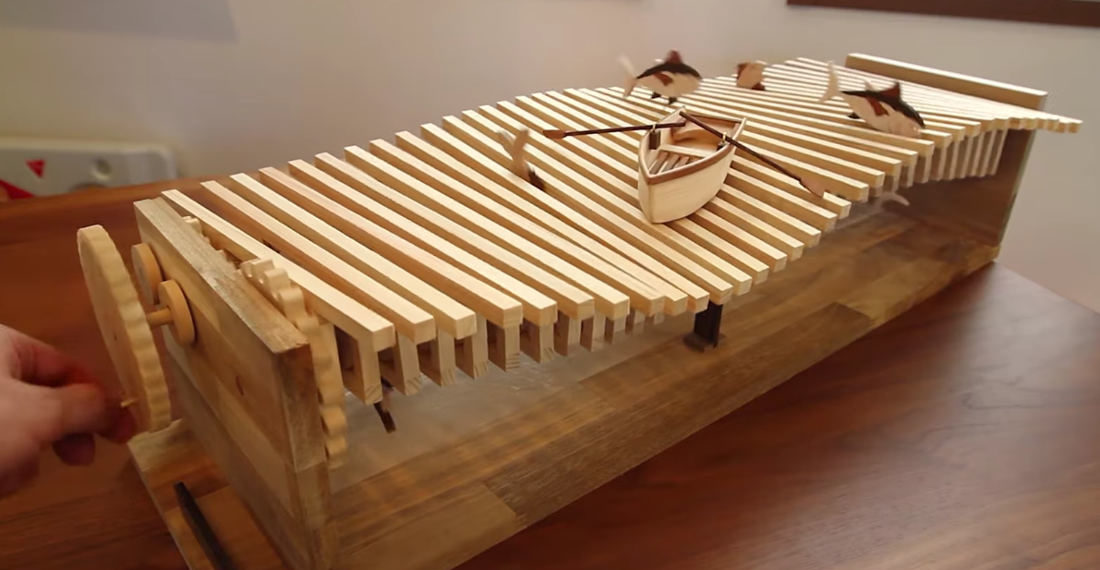 A Beautiful Kinetic Sculpture Of A Boat Bobbing Up And Down On Wooden Waves