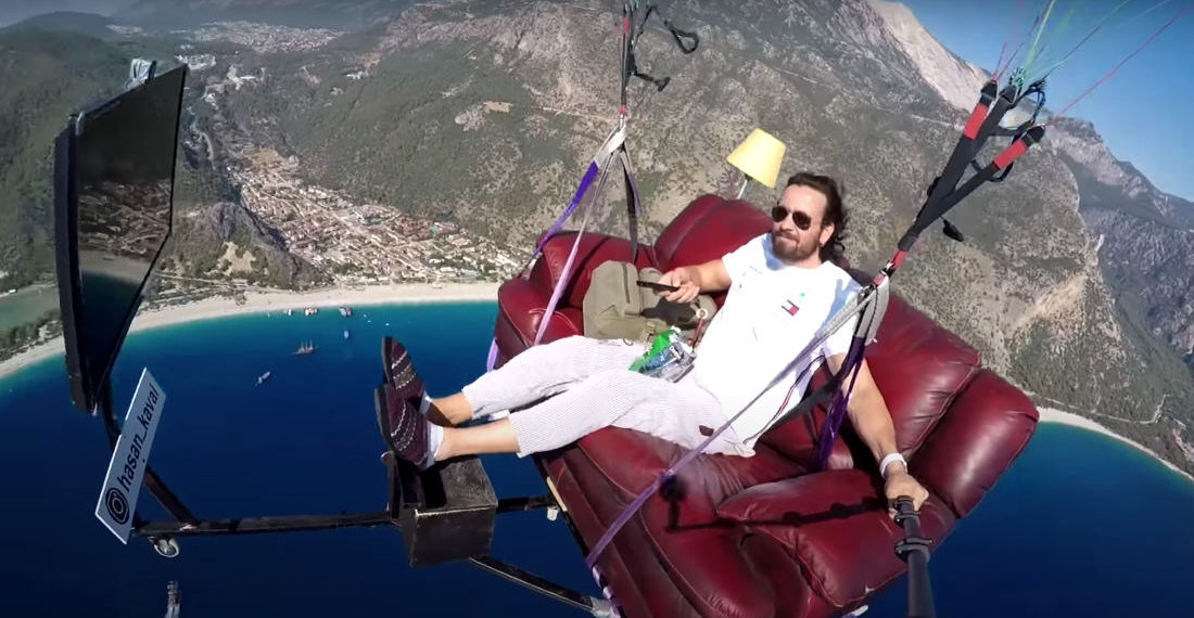 Lunatic Goes Paragliding On Couch Setup With Television
