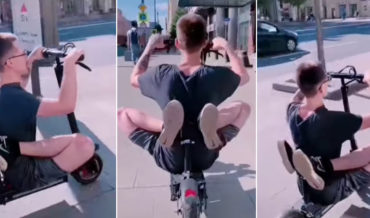 What The: Guy Riding Scooter With Feet Behind His Back