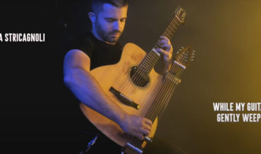 Guitarist Performs The Beatles’ ‘While My Guitar Gently Weeps’ On Acoustic Guitar With Slide Guitar Neck Attachment