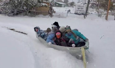 Sure, Why Not?: Kids Sledding In A Boat Pulled Behind ATV