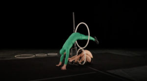 Acrobatic Troupe's Skillful Jumping Through Hoops Routine