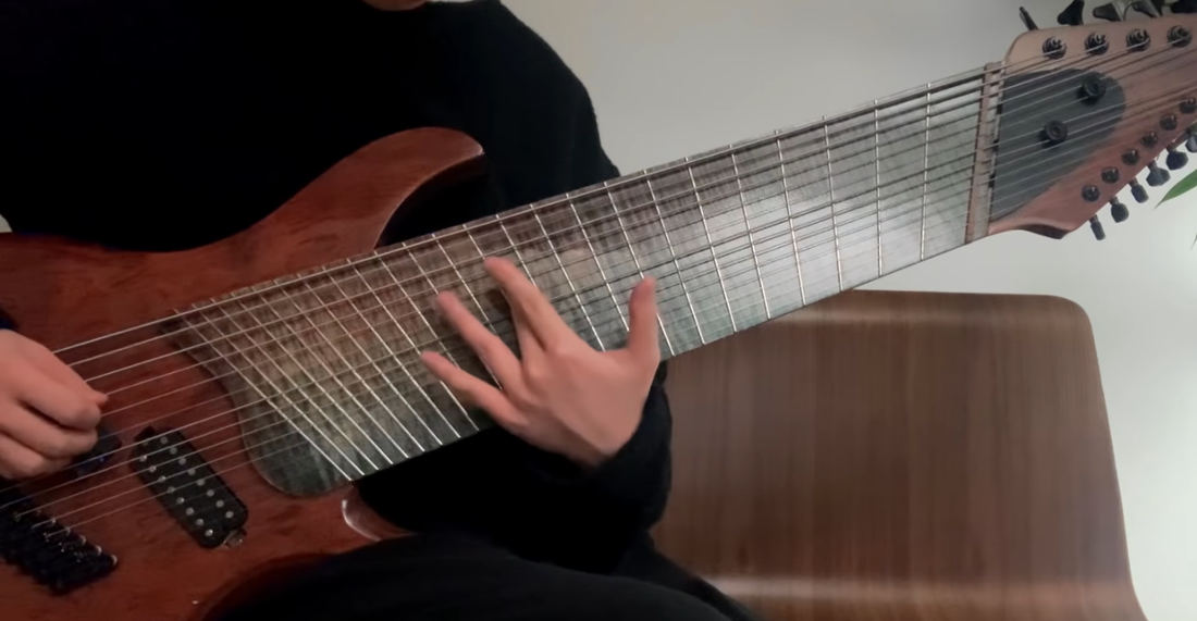 Man Demonstrates Playing His Ultrawide 14 String Electric Guitar
