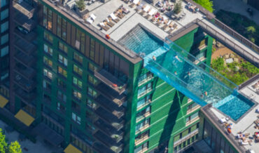 Clear Pool Connecting Two Apartment Buildings 115-Feet High Opening In London