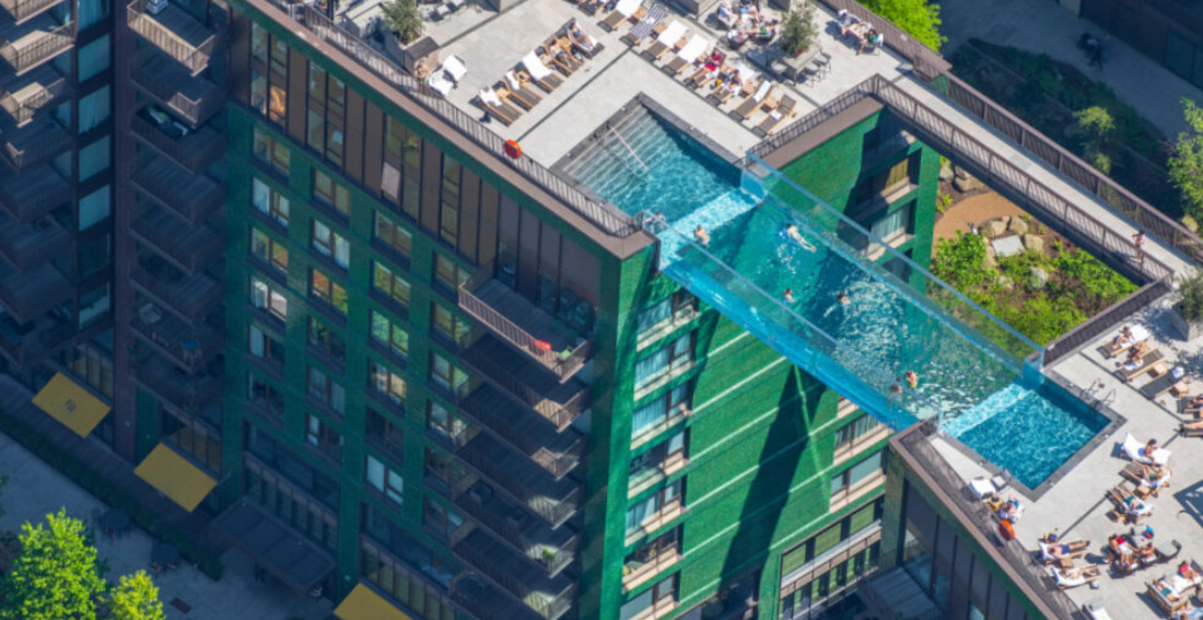Clear Pool Connecting Two Apartment Buildings 115-Feet High Opening In London