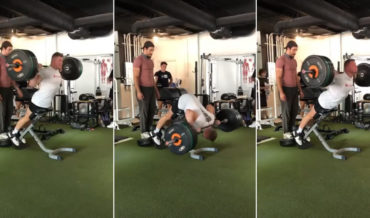 Man Performs Extremely Heavy Weight Back Extensions