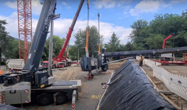 Toppled Crane Being Hoisted By Another Crane Almost Falls On Workers
