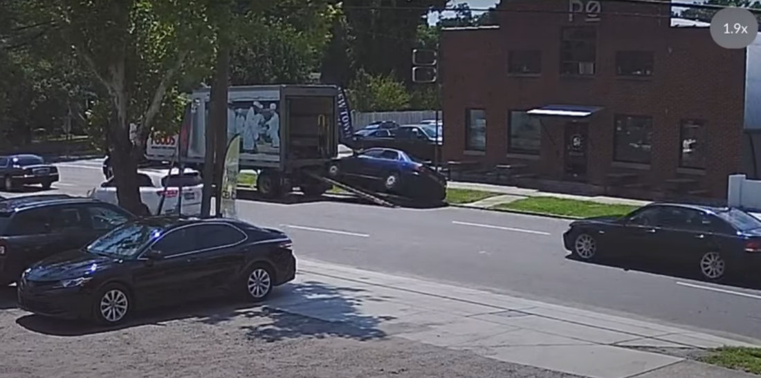 Woman Drives Up Ramp To Back Of Delivery Truck