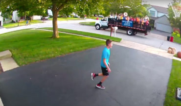 Kid Shooting Hoops In Driveway Sinks Shot, Passing Marching Band Plays Him Off