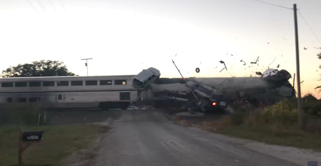 Train Hits Car Hauler Stuck On Tracks, Cars Go Flying