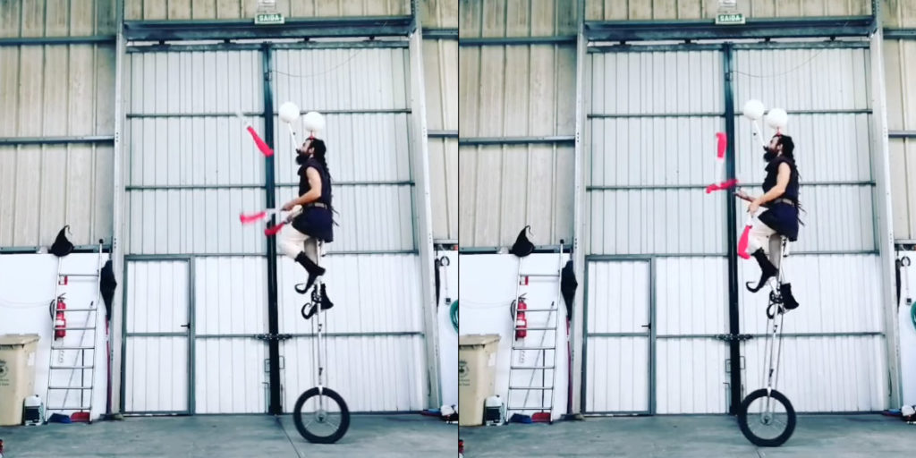 Elf On X-Tall Unicycle Balances Two Spinning Balls On Head While Juggling