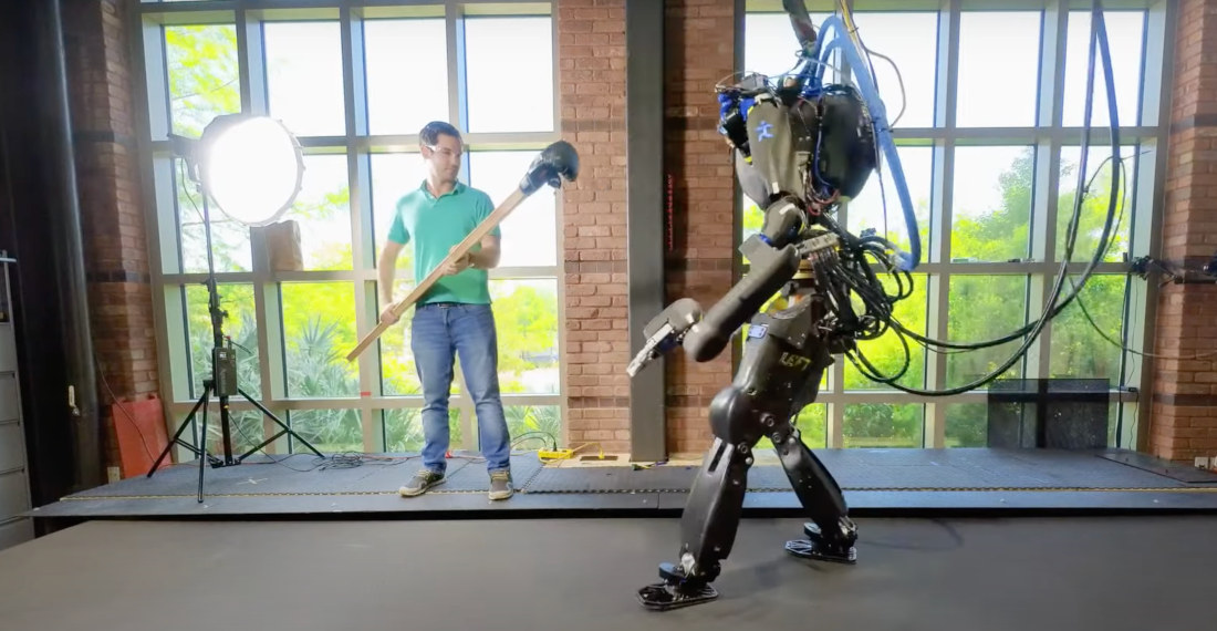 Humanoid Robot Maintains Balance After Getting Shoved On Treadmill