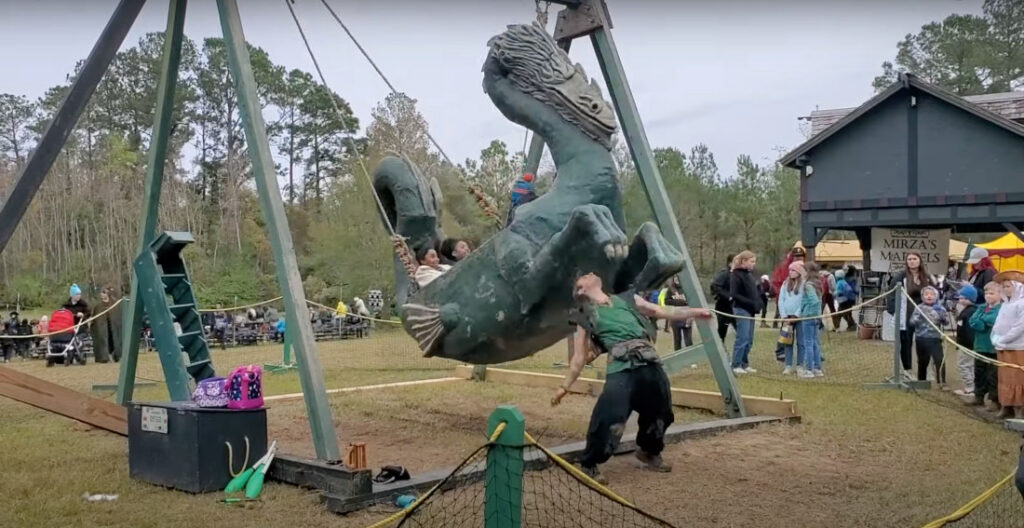Dragon Tamer Performs Tricks With Dragon Swing At Renaissance fair