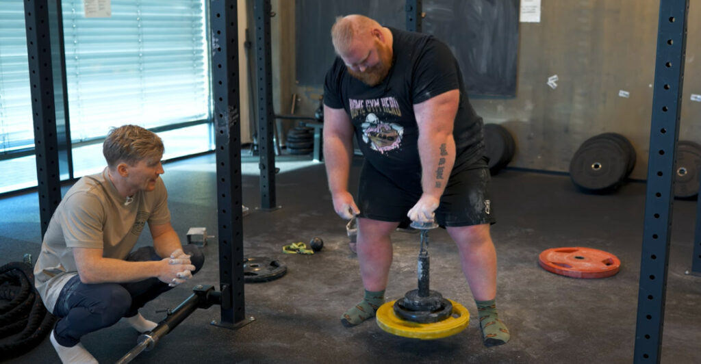 Strongman Competes With Rock Climber In Grip Strength Competition