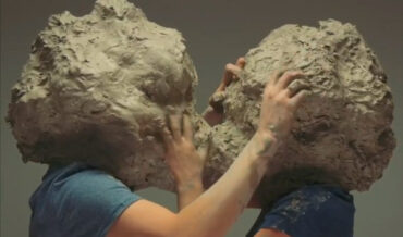 Two Giant Clay Headed People Making Out