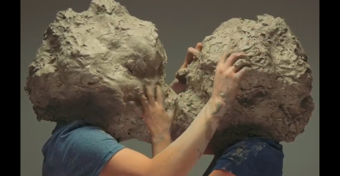 Two Giant Clay Headed People Making Out