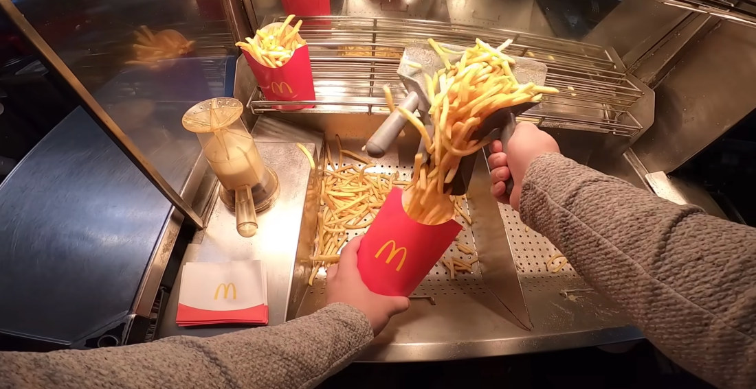 First Person POV Of McDonald’s Employee Preparing Fries And Hash Browns