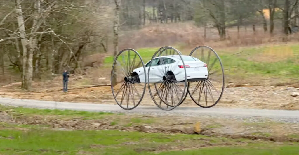 Driving A Tesla With 10-Foot Wagon Wheels (And Upside Down)