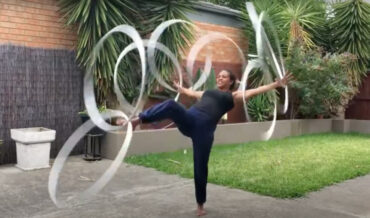 Woman Simultaneously Spins 8 Hula Hoops On All Her Extremities