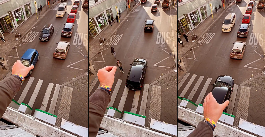 Forced Perspective Video Of Man Moving Traffic With His Hand