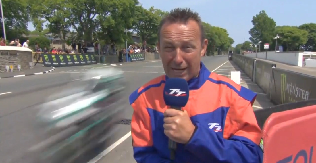 Isle Of Man Trackside Reporter Reacts To Motorcycle Racers Passing At Full Speed