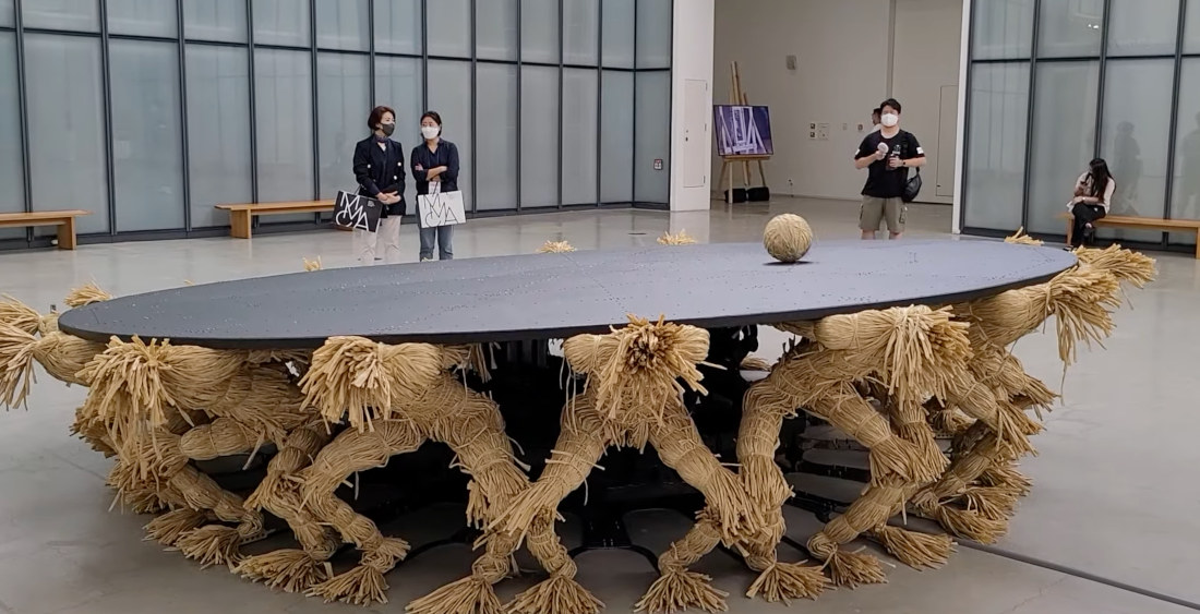 Kinetic Sculpture Of 18 Headless Figures Keep ‘Head’ Rolling Around On Their Backs