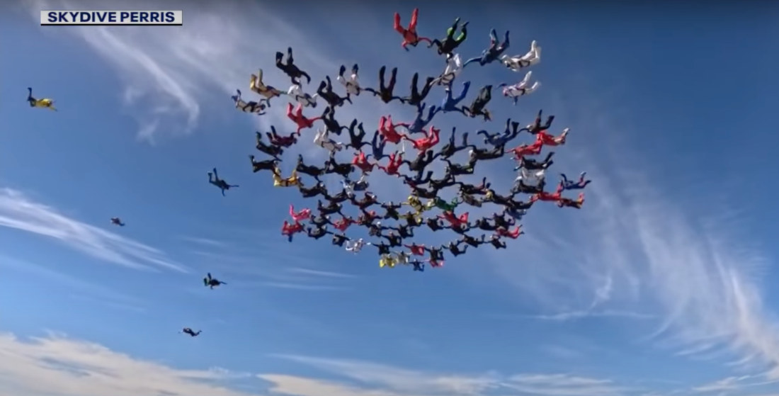 101 Skydivers Over 60 Link Together To Form Giant Snowflake Formation