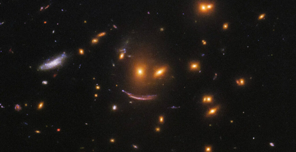 Hubble Space Telescope Spots Smiley Face Galaxy Cluster