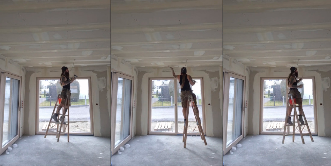 Construction Worker Dances Stepladder Around Room Finishing Drywall Ceiling