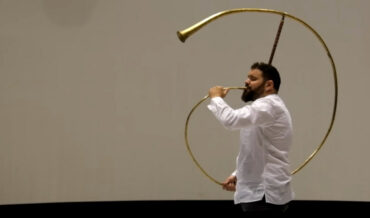 Playing the Cornu de Pompeii, A Replica Of A Horn Found In The Ruins Of Pompeii