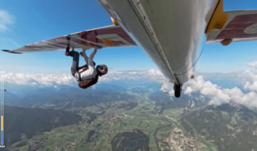 Climber Attempts Climbing Route Under Wings Of Flying Plane