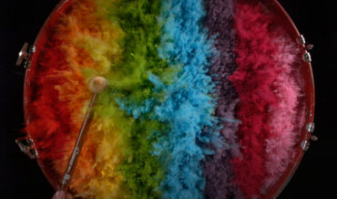 Banging A Drum Covered In A Rainbow Of Paint Pigment In Ultra Slow Motion